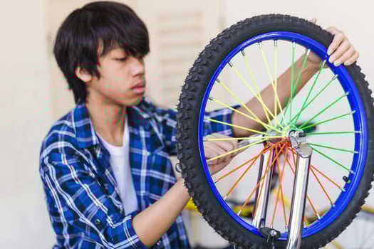 Boy fixing bicycle, Mechanical hobby and repair concepts. photo