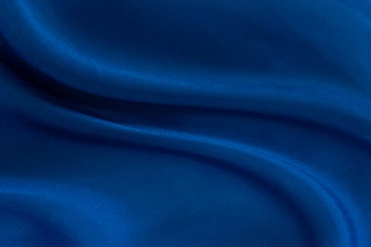 Luxury deep blue fabric background.Smooth wavy fold pattern.Elegant curve.Silk velvet material texture.Using for backdrop or wallpaper.Dark tone color. photo