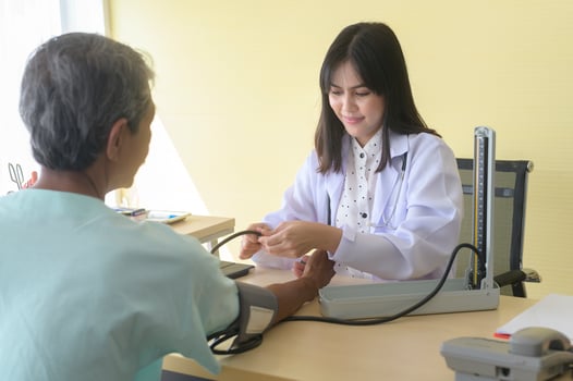 Asian senior male patient is consulting and visiting doctor in hospital.. photo
