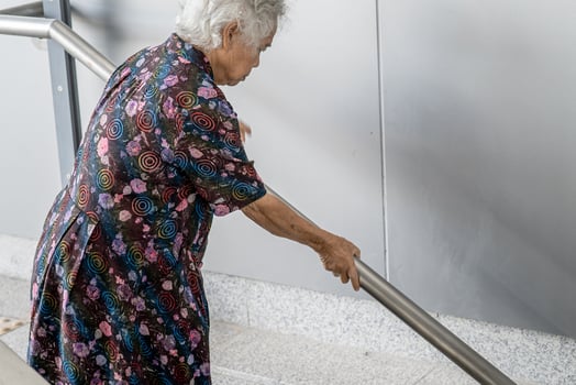 Asian senior or elderly old lady woman patient use handle at stairs security support in building, healthy strong medical concept. photo