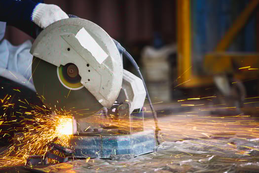 Cutting of a steel with splashes of sparks,  Metal processing with angle grinder. Sparks in metalworking. photo
