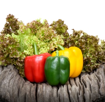 Fresh sweet peppers and lettuce on wooden background isolated on white background photo