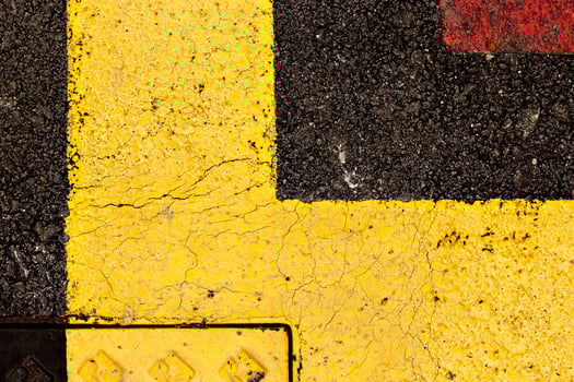 Asphalt painted yellow and red, suitable for textured abstract background. photo