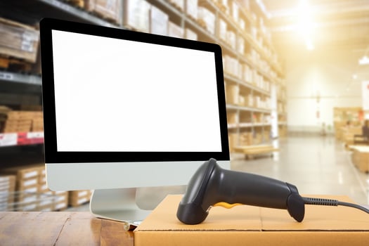 Woman scanning barcode from a label in modern warehouse photo