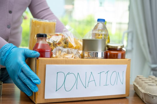 Foodstuff for donation, storage and delivery. Various food, pasta, cooking oil and canned food in cardboard box. photo