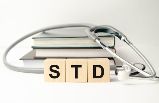 Wooden blocks with the inscription STD with stethoscope on the doctor's desktop photo