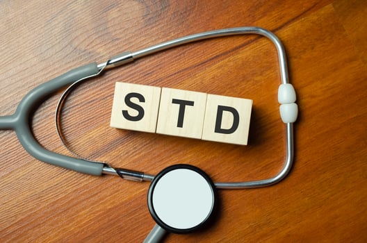 Wooden blocks with the inscription STD with stethoscope on the doctor's desktop photo
