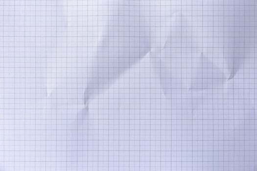 Square crumpled square graph paper on the background. photo