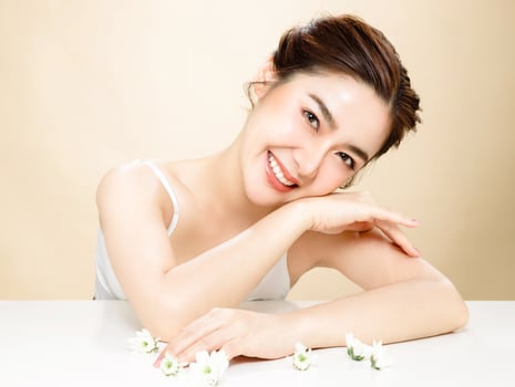Asian woman with a beautiful face and fresh, smooth skin is dressed in pink. photo