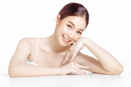 Asian woman with a beautiful face gathered in a brown ponytail and clean fresh smooth skin. photo