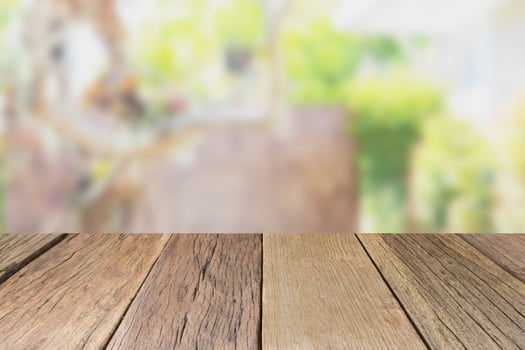 Empty wooden table top perspective with blur green garden background, used for montage or display your products photo