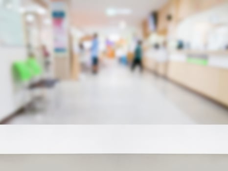 Empty white desk with blur hospital background photo