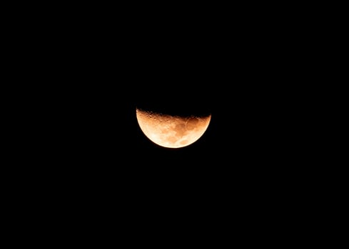Beautiful texture of half moon during the waxing crescent phase in night sky photo