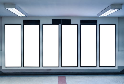 Row of empty digital vertical billboard on wall photo