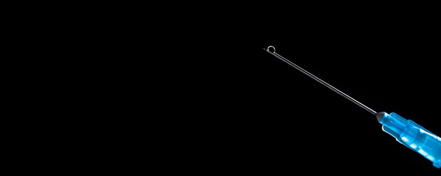 Medical syringe with a needle and vaccine against corona virus. photo
