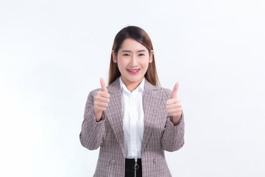 Beautiful business woman Long Hair Asian In a suit, smiling and thumbs up and presenting something on a white background. photo