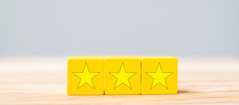 wooden blocks with the star symbol. Customer reviews, feedback, rating, ranking and service concept. photo