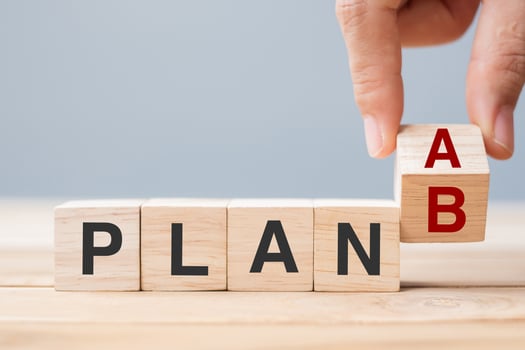 Businessman hand flipping wooden cube blocks with PLAN A change to PLAN B text on table background. strategy, leadership, management, marketing, project and Crisis concepts photo