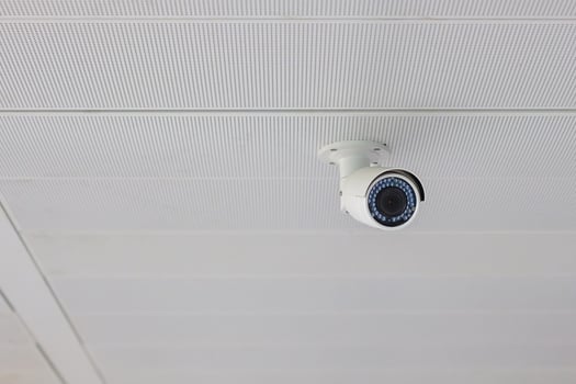 Modern Security Camera with office or house background, cctv to record and property protection for car park photo