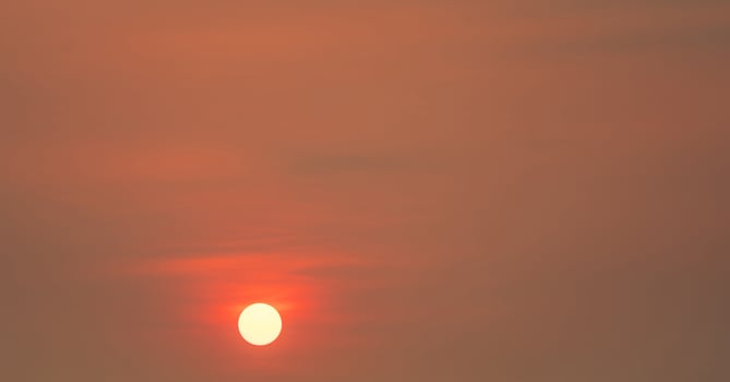 Round big sun and red sunset sky in the evening with space for inspiration quote. Beauty in nature. Beautiful summer sunset sky. Tranquil and peaceful background. Panorama scene of red sky. photo