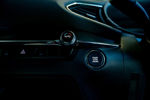 Start stop engine button of luxury car. Push up button for start or stop car engine in keyless automobile. Turn key with ignition system concept. Black ignition switch. Car air conditioning knob. photo