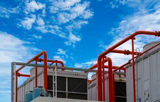 Cooling tower on roof top of building. Industrial air cooling system. Air chiller. Unit of air conditioner. Air cooled chiller with piping system on rooftop of building. Cooling tower outside building photo