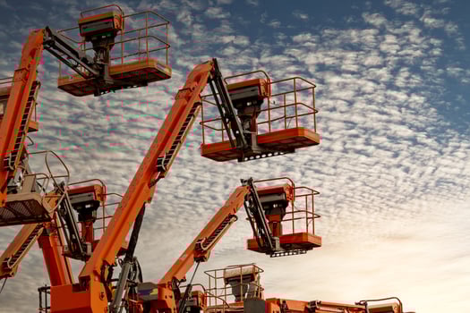 Articulated boom lift. Aerial platform lift. Telescopic boom lift against blue sky. Mobile construction crane for rent and sale. Maintenance and repair hydraulic boom lift service. Crane dealership. photo