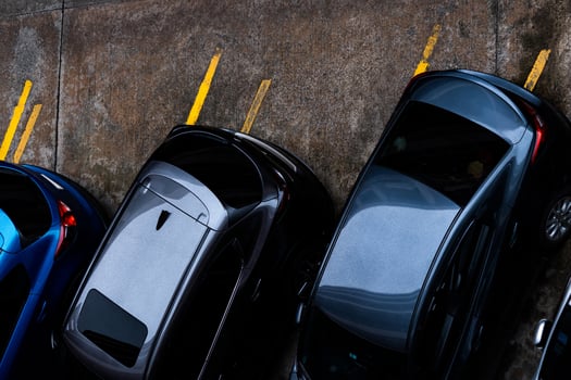 Top view of car parked at concrete parking lot. Above view of car at parking space. Outside automobile parking area. Used car market. Automotive industry. Used automobile for rental. Car on the road. photo