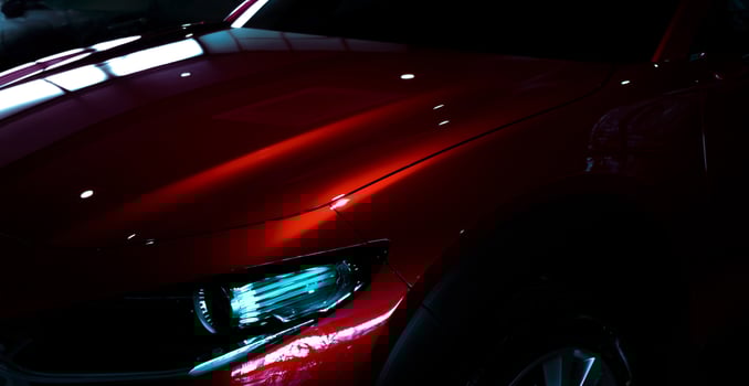 Selective focus on shiny red luxury SUV car in showroom. Elegant electric car with sport design. Car parked in showroom. Car dealership. Electric vehicle development concept. Future transportation. photo