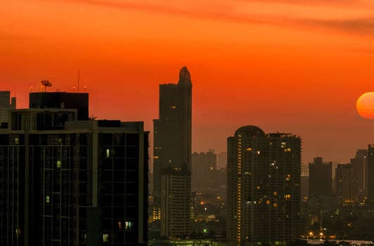 Cityscape with beautiful morning sunrise sky. Air pollution in Bangkok, Thailand. Smog and fine dust of pm2.5 covered the city. Cityscape with polluted air. Dirty environment. Urban toxic dust. photo