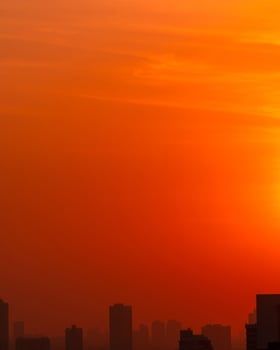 City in the morning with red sunrise sky and smog. Air pollution. Cityscape with polluted air. Urban toxic dust. Unhealthy air. Unhealthy living. Climate change concept. Environmental pollution. photo