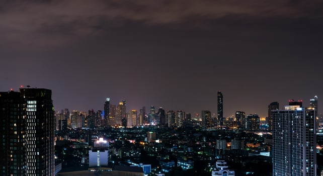 Cityscape of modern building in the night. Modern architecture office building. Skyscraper with beautiful evening sky. Business and financial center building. Apartment in the city with night light. photo