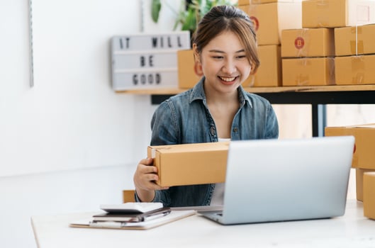 Small Business SME entrepreneur of Young Asian women working with laptop for Online shopping at home,Cheerful and Happy with box for packaging in home,Own Business Start up for Business Online photo