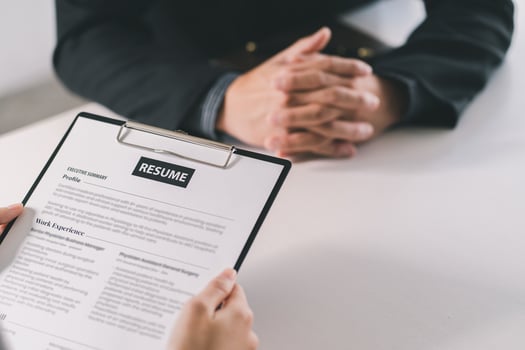 Cropped view of person holding pen and filling out application form on table photo