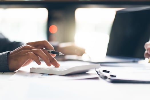 Close up hand of stress young asian businessman,male is pressing a calculator to calculate tax income and expenses, bills, credit card for payment or payday at home, office.Financial, finance concept. photo