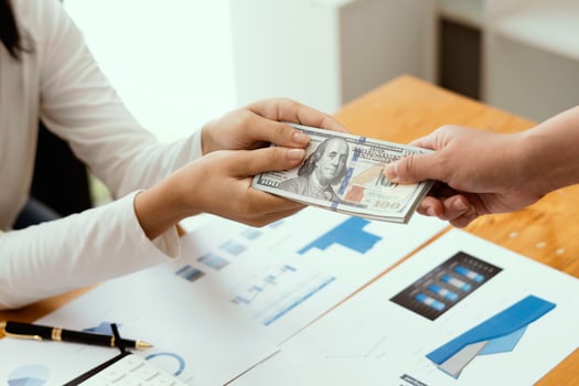 Businessman giving or paying money, US dollar bills photo
