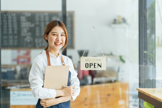 Smiling waitress or cafe business owner entrepreneur looking at camera photo