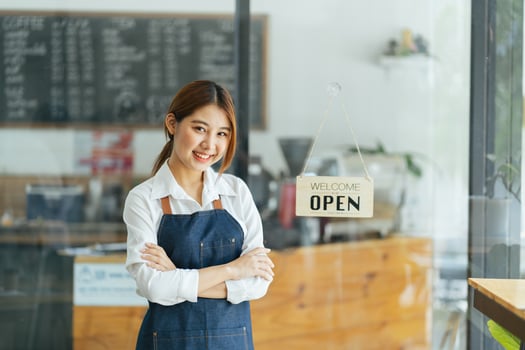 Smiling waitress or cafe business owner entrepreneur looking at camera photo