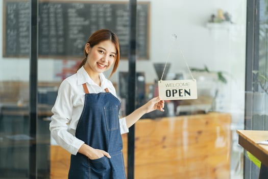 Smiling waitress or cafe business owner entrepreneur looking at camera photo