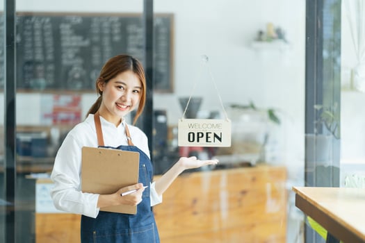 Smiling waitress or cafe business owner entrepreneur looking at camera photo