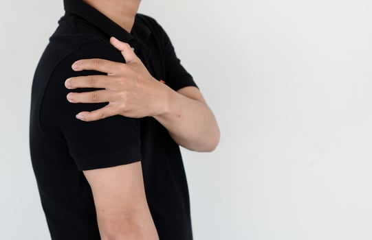 Healthcare concept, a man has severe shoulder pain due to overwork and office syndrome. photo