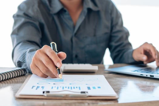 Close up of accountant or banker checking investment results, calculates financial savings, calculates annual taxes and economic concepts. Financial calculation concept. photo