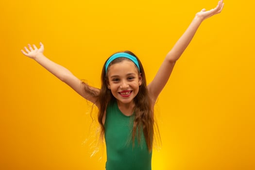 Football supporter, Brazil team. World Cup. Beautiful little girl cheering for her team on yellow background photo
