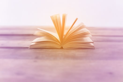Open book on wood planks over abstract light background photo