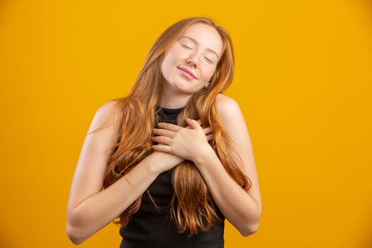 Happy valentines day, love. Cute and tender romantic redhead girlfriend hands in your heart, confess in sympathy, express passion or like, admire amazing artwork, appreciate, stand yellow background. photo