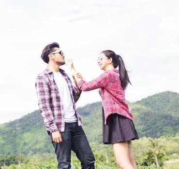 Young hipster couple holding hands walking on the meadow relaxing and natural atmosphere is very natural. photo