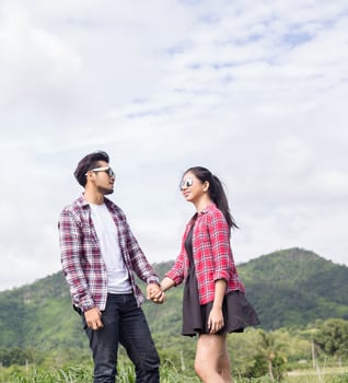 Young hipster couple holding hands walking on the meadow relaxing and natural atmosphere is very natural. photo