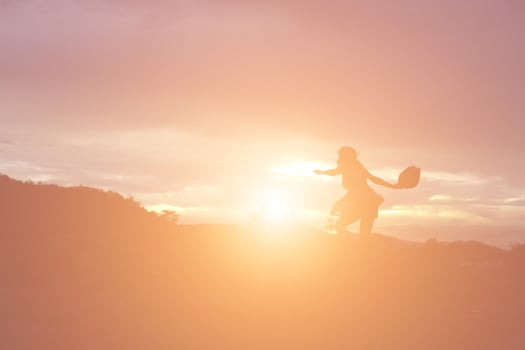 Silhouette of woman praying over beautiful sky background photo