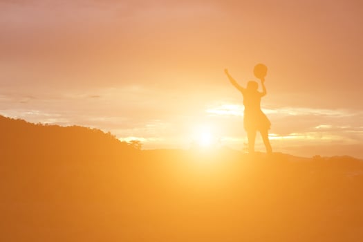 Silhouette of woman praying over beautiful sky background photo