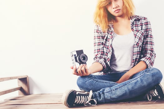 Young beautiful hipster woman with an old retro camera. photo